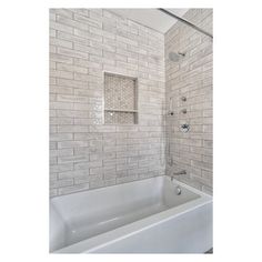 a white bath tub sitting next to a walk in shower