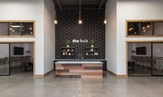 the hub is located in an industrial building with glass doors and wooden accents on the walls