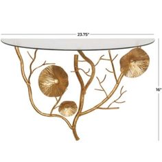 a table with gold leaves on it and a glass top in the shape of a tree