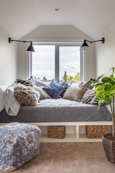 a living room filled with lots of furniture and pillows