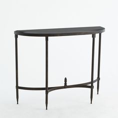 a black console table with an oval shaped top and curved legs, against a white background