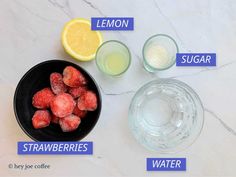 the ingredients to make lemonade are displayed on a marble counter top, including strawberries and water