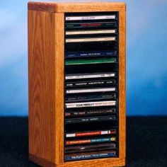 a wooden cd rack with many dvds in it