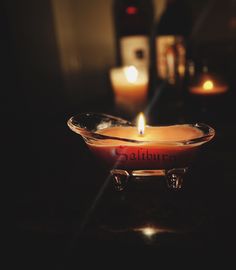 a candle that is sitting in a glass bowl