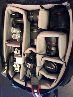 the inside of a camera bag filled with cameras