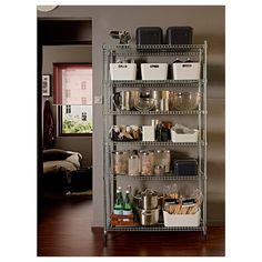 a metal shelving unit filled with lots of food and drinks on top of a hard wood floor