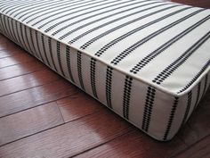 a close up of a mattress on a wooden floor in a room with hard wood floors