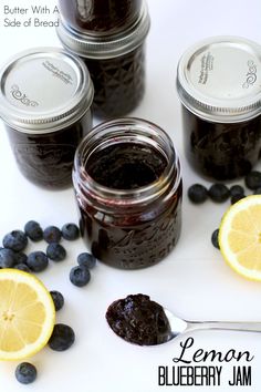 lemon blueberry jam in mason jars with fresh blueberries around the jar and spoon