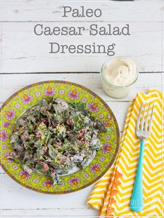 paleo caesar salad dressing on a yellow and white plate next to a blue fork