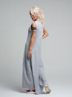 Our grey maxi dress is the epitome of laid-back chic, made from soft viscose that drapes beautifully for a comfortable yet stylish look. Its sleeveless design and subtle scoop neckline offer a casual elegance that's perfect for sunny days or layered under a jacket when the evening cools down. FEATURES:Sleeveless with a relaxed fit and a long, flowing silhouette. Ideal for leisurely weekend wear or as a base for accessorizing100% Handmade. SIZE & FIT: Fit: A relaxed fit with room to moveModel is wearing size Small or S/M View our SIZE CHART before ordering MATERIALS & CARE: Content: 65% Cotton, 35% Polyester Care: Machine wash on cold (30ºC) with a mild detergent. SHIPPING: Made to order, the processing time is 15 working days This item will be shipped via DHL Casual Gray Sleeveless Maxi Dress, Sleeveless Gray Maxi Dress For Spring, Casual Sleeveless Maxi Dress For Loungewear, Chic Gray Maxi Dress, Gray Floor-length Maxi Dress, Grey Maxi, Grey Maxi Dress, Stocking Fillers For Her, Dresses Xxl