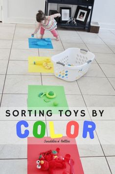 a toddler playing with colored toys on the floor in front of a bookcase that reads sorting toys by color