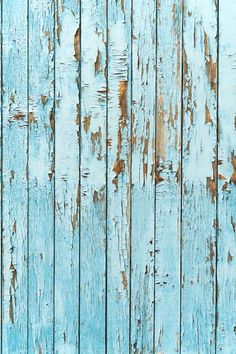 an old blue wooden wall with peeling paint