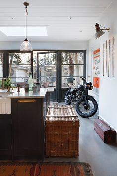 a kitchen with a motorcycle parked in the center