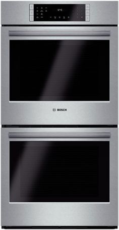 two ovens side by side, one with the door open and one with the light on