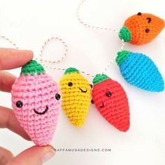 crocheted fruit ornament being held by someone's hand with four different colors