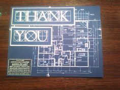 a blueprint on a wooden table showing the floor plan