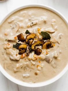 a white bowl filled with soup on top of a table