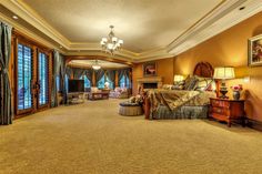 a bedroom with a large bed sitting in the middle of a living room next to a doorway