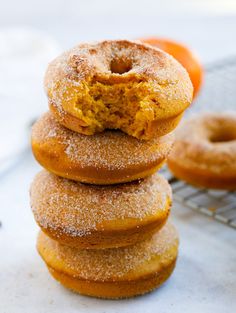 a stack of doughnuts sitting on top of a cooling rack