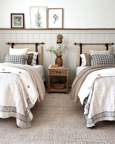 two twin beds in a bedroom with white walls