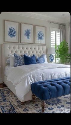 a bedroom with blue and white decor on the walls