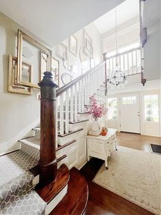 the stairs in this house are made of wood and have white trimmings on them