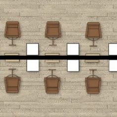 an overhead view of office chairs and desks in front of a brick wall with white frames