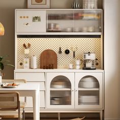 a kitchen with white cabinets and appliances in it's centerpiece, along with a dining room table