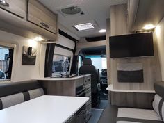 the interior of an rv is clean and ready to be used as a dining area