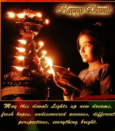 a woman holding a lit candle in her hand with the words happy diwali on it