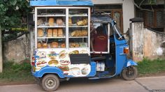 a small food cart parked next to a building