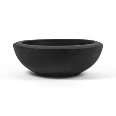 a black bowl sitting on top of a white table