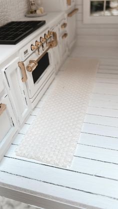 a white stove top oven sitting inside of a kitchen