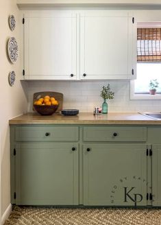 a bowl of oranges sitting on top of a kitchen counter