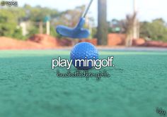 a blue golf ball sitting on top of a green field