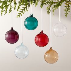 three ornaments hanging from a christmas tree