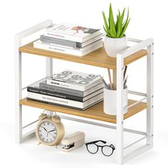 a shelf with books, glasses and a clock next to a potted aloen