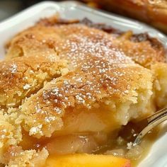 a close up of a piece of pie on a plate with a fork in it