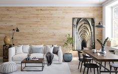 a living room filled with furniture and wooden walls