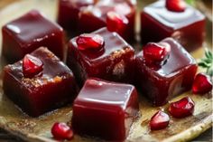 several pieces of chocolate with pomegranate on top