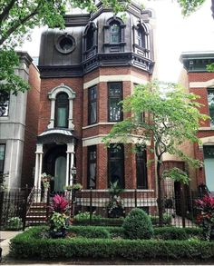 a large brick house with many windows and balconies