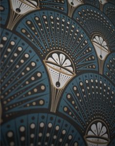 an art deco wallpaper with blue and gold fan design on the front, black background