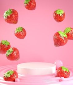 several strawberries are falling into the air on a pink surface with white circles around them