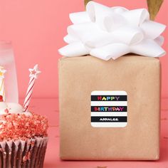 a birthday cupcake sitting next to a brown box