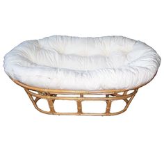 a round dog bed made out of wicker with white fabric on the top and bottom