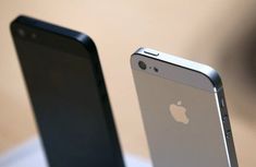 two iphones sitting next to each other on a table