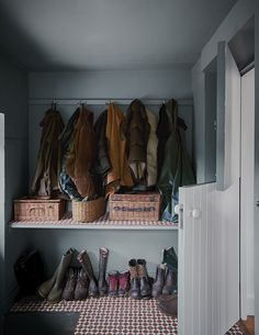 several pairs of shoes are lined up on a shelf in a room with checkered flooring