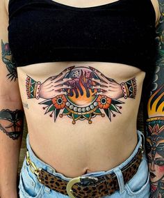 a woman's stomach with tattoos on it