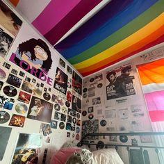 a bedroom with a rainbow colored ceiling and wallpaper on the walls is pictured in this image