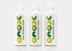 three bottles of coconut water on a white surface